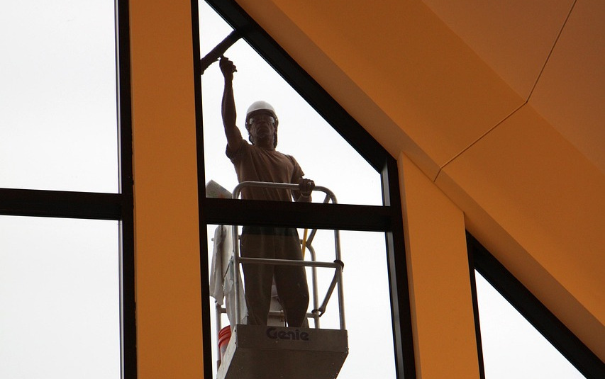 worker using squeegee on window